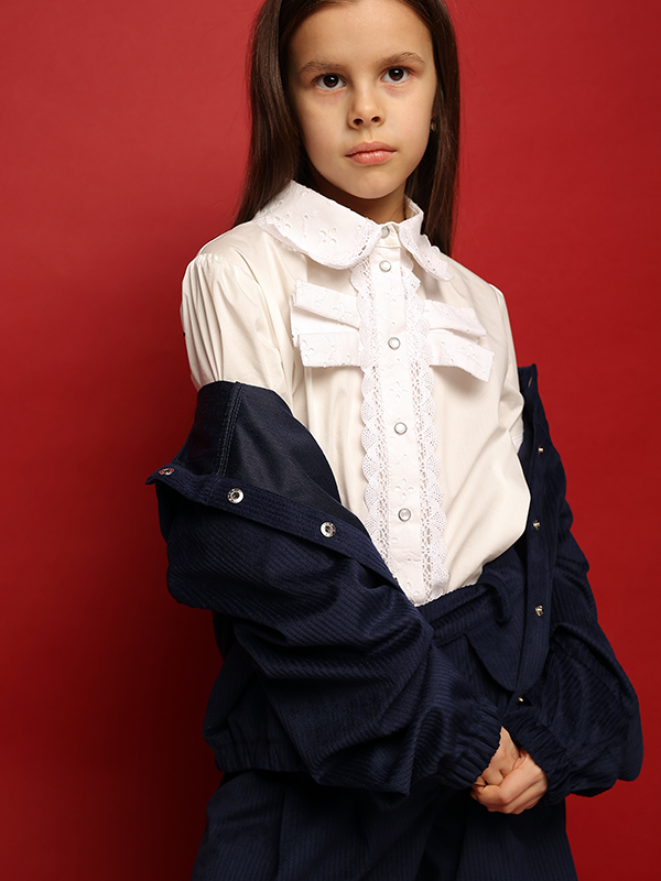 Нарядная белая школьная блузка со вставками из шитья с бантом на лифе